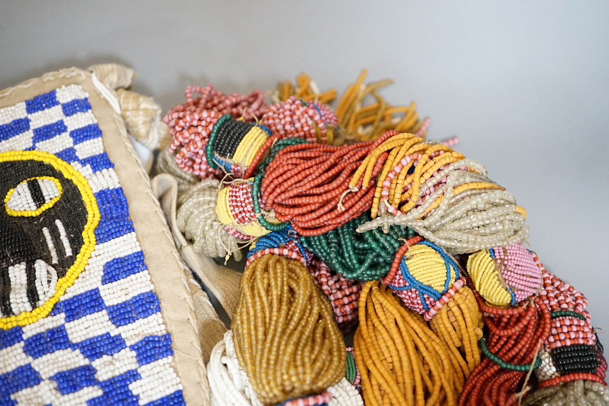 A large African beadwork necklace and three beadwork bags